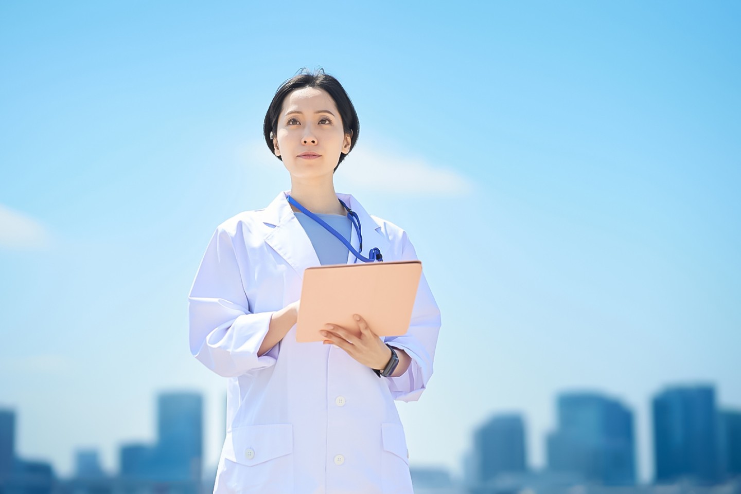 A woman in a white coat holding a file